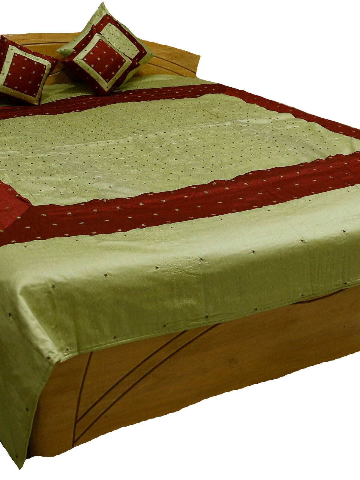 Pistachio green silk bedcover with maroon bands and mirror work dots, matching cushions
