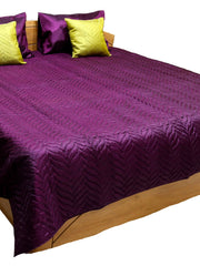 Deep purple embossed quilted double bedcover with matching purple pillow covers and chartreuse-yellow embossed cushion covers