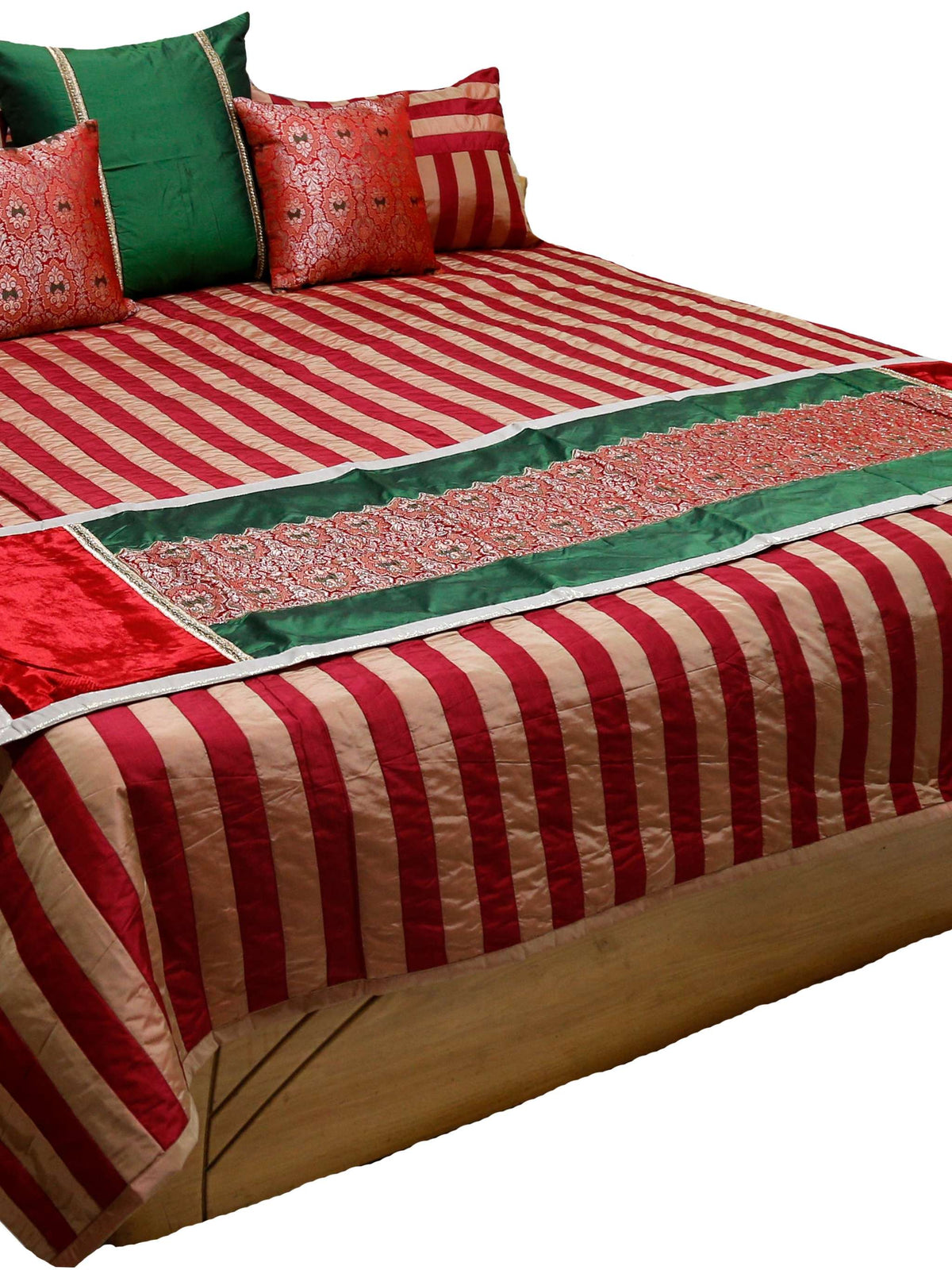 Red and cream striped double bedcover with a green and red brocade runner, matching striped pillow covers and patterned cushion covers