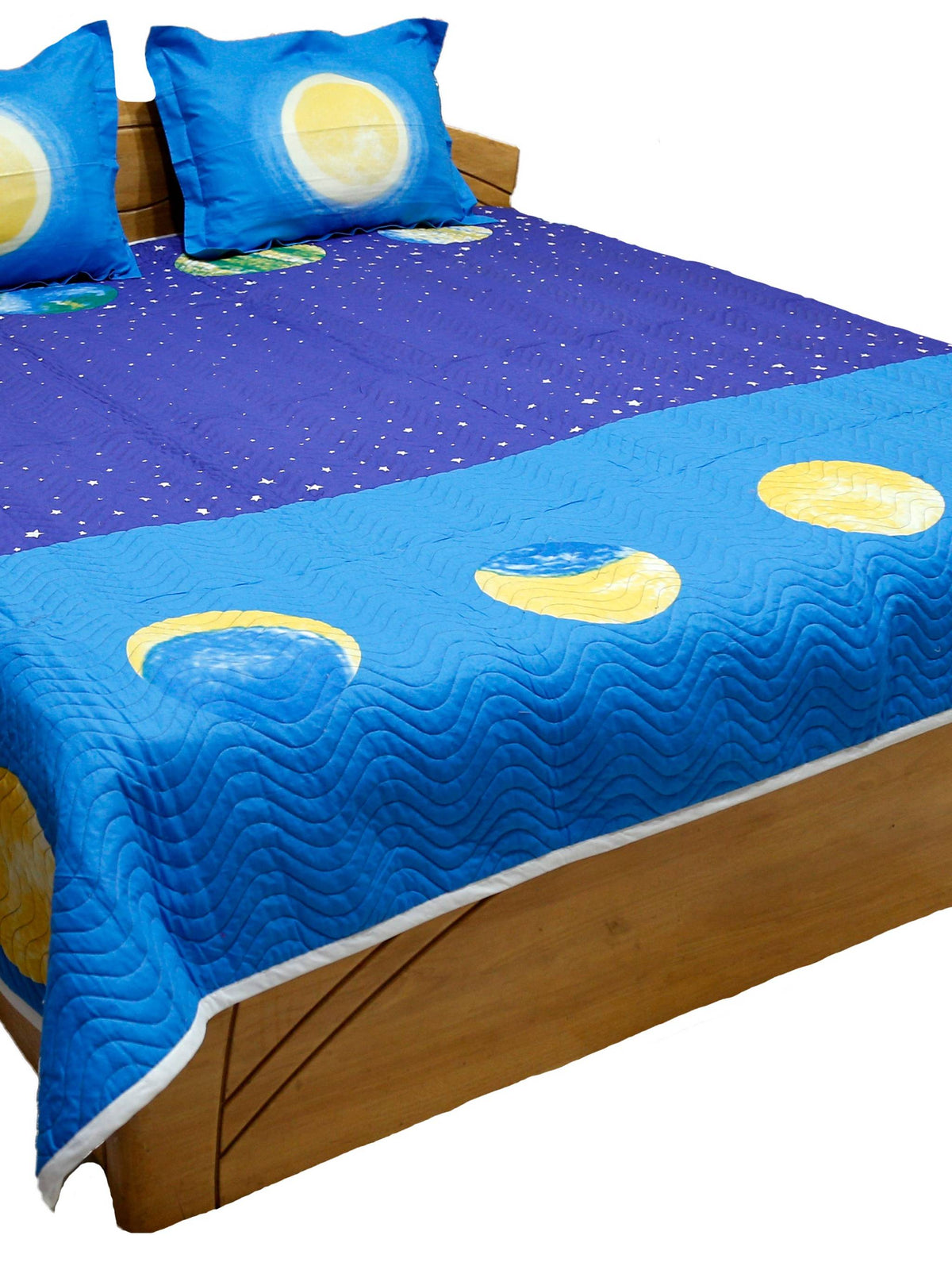 Blue children's bedcover printed with moons, planets and stars, angled view