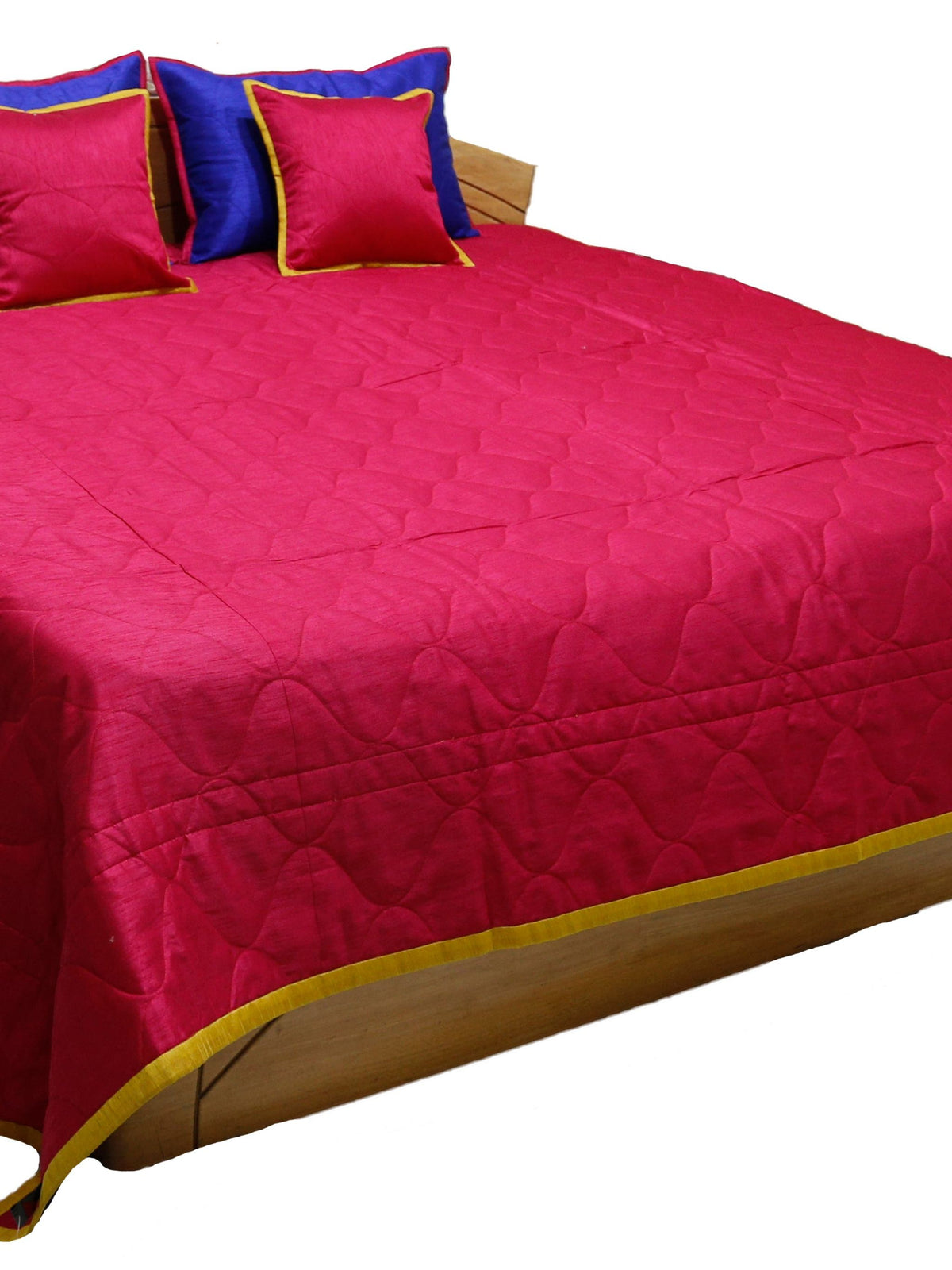 Crimson reverse side of the bedcover with royal blue and gold cushion covers