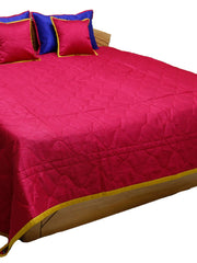Crimson reverse side of the bedcover with royal blue and gold cushion covers