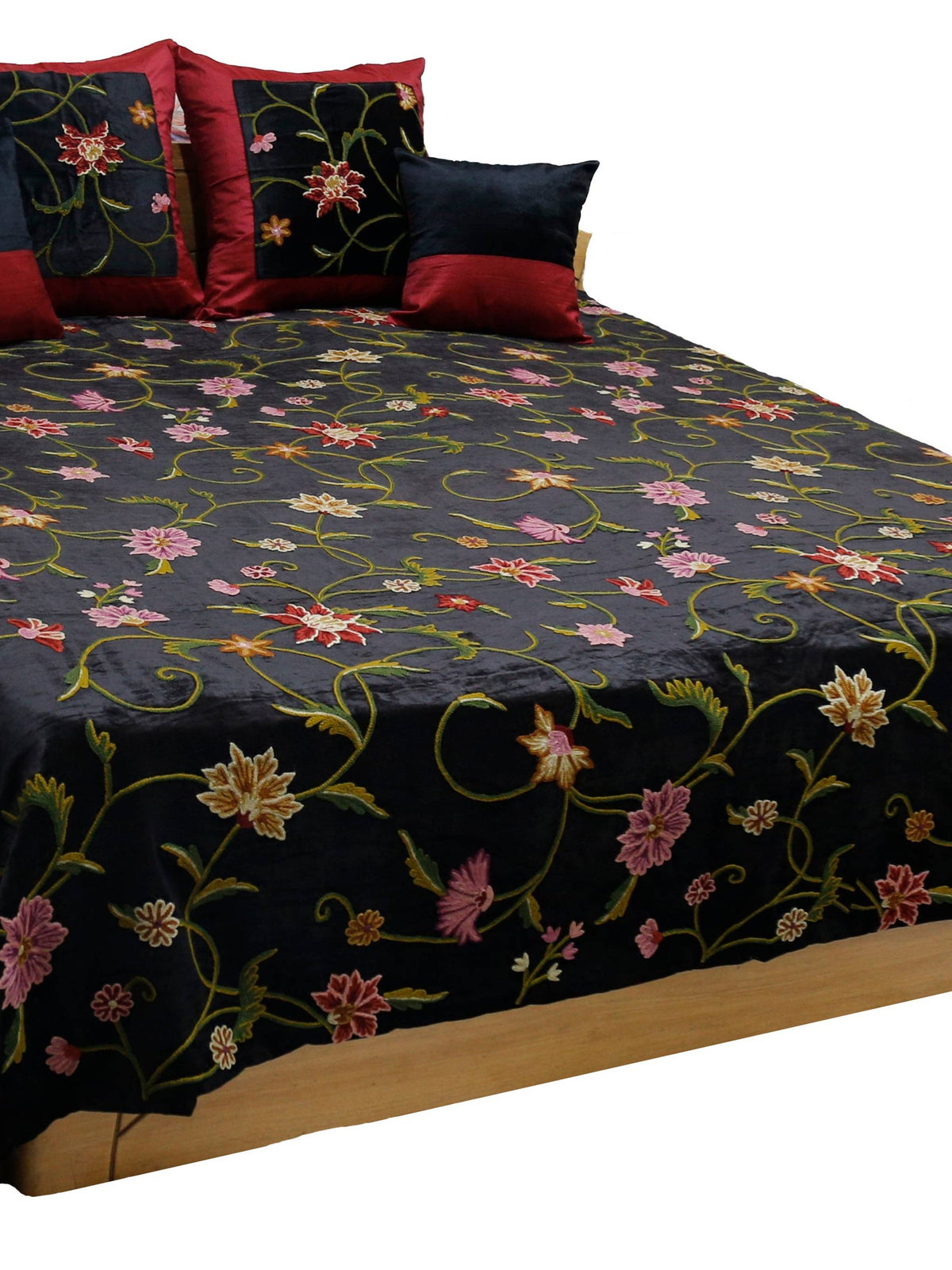 Black velvet double bedcover with a multicolour crewel floral embroidery, styled with 4 matching cushion covers in maroon and black velvet