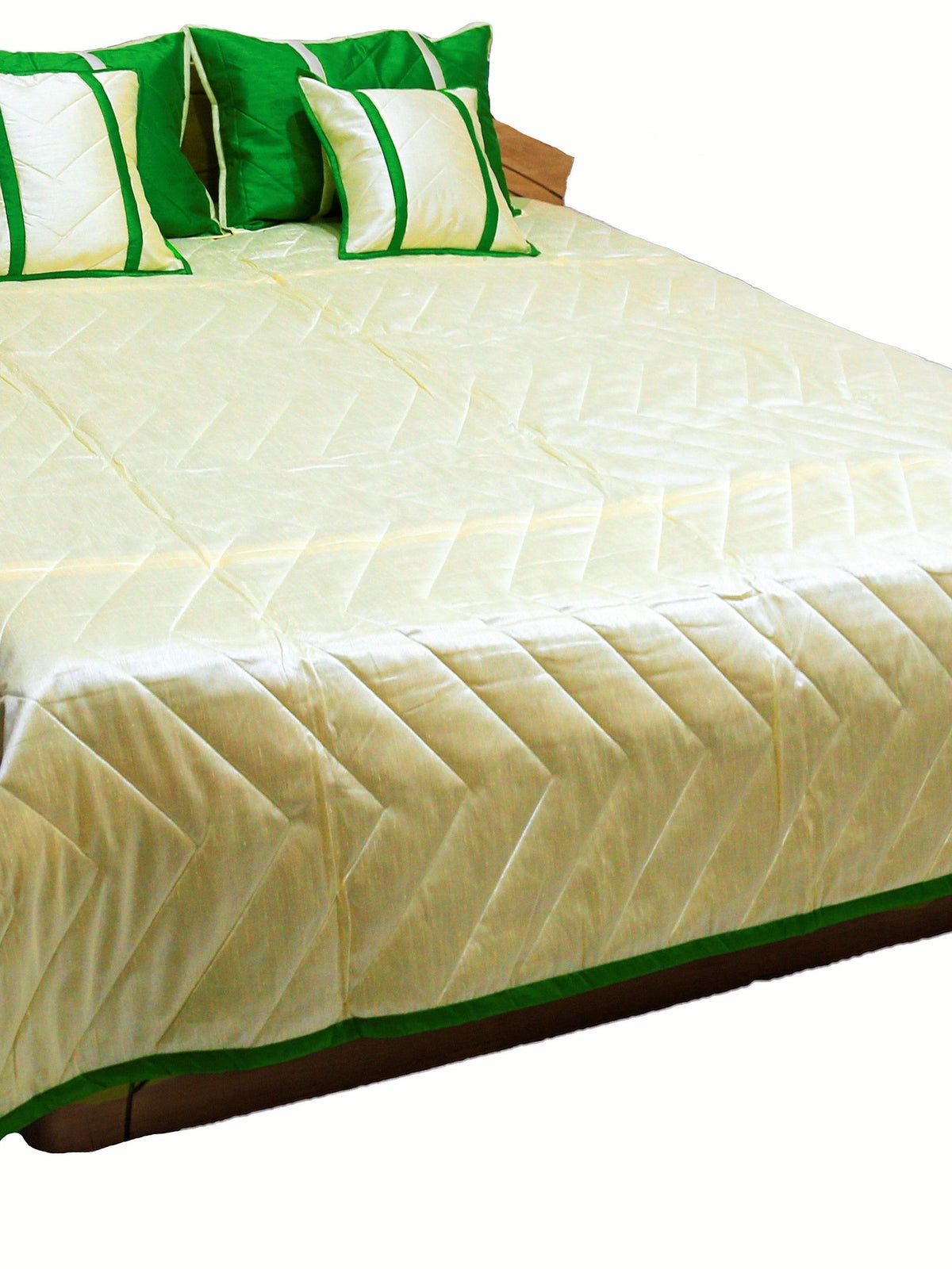 Cream reverse side of the bedcover with green bordered edge and green cushions