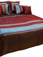 Maroon bedcover with brown and blue bands, mirror work dots and six cushions