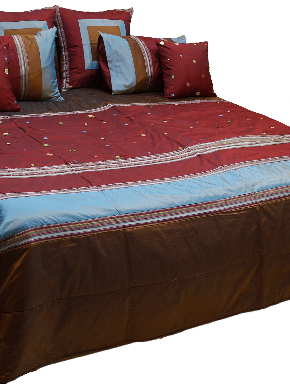 Maroon bedcover with brown and blue bands, mirror work dots and six cushions