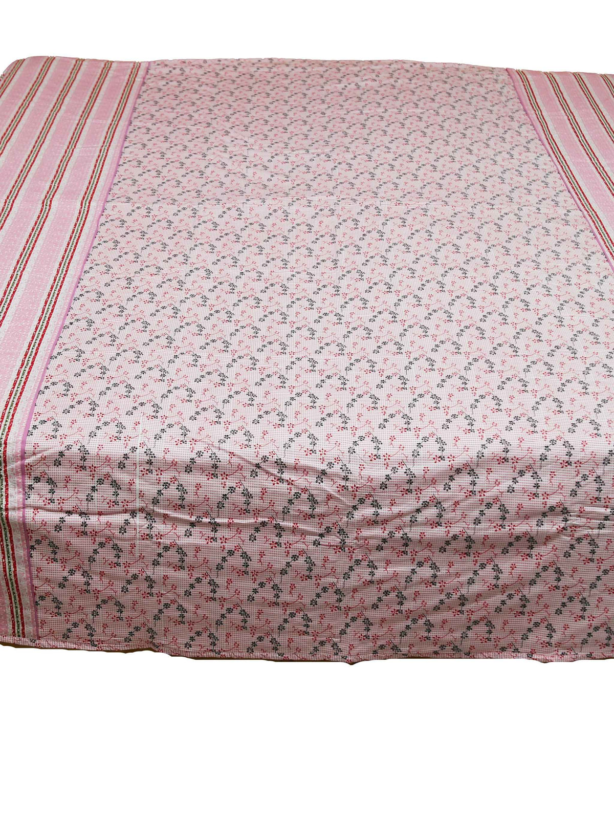 Dusty pink floral print dohar spread over a bed with striped pink and green borders