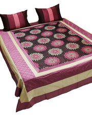 Wine and black bedcover with pink lotus medallions, cream border and two cushions