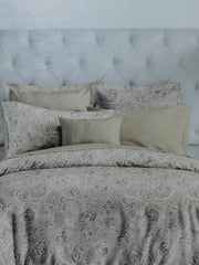 Grey paisley print cotton bedding made up on a tufted bed, Trident Nectarsoft