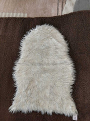 Cream faux sheepskin bedside runner with a long shaggy pile
