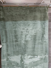 Sage green artificial fur rug with a long, soft pile