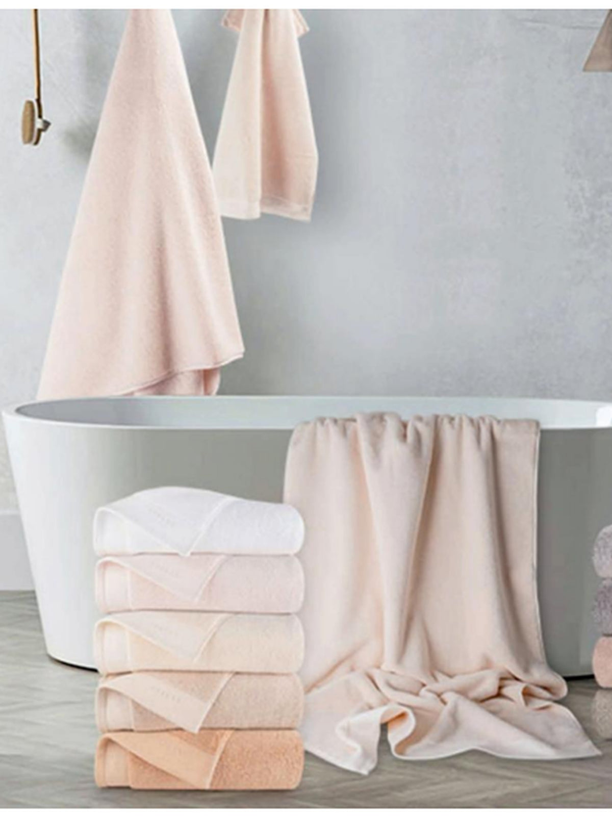 Blush cotton towels stacked and hanging beside a freestanding bath, Resort Towel