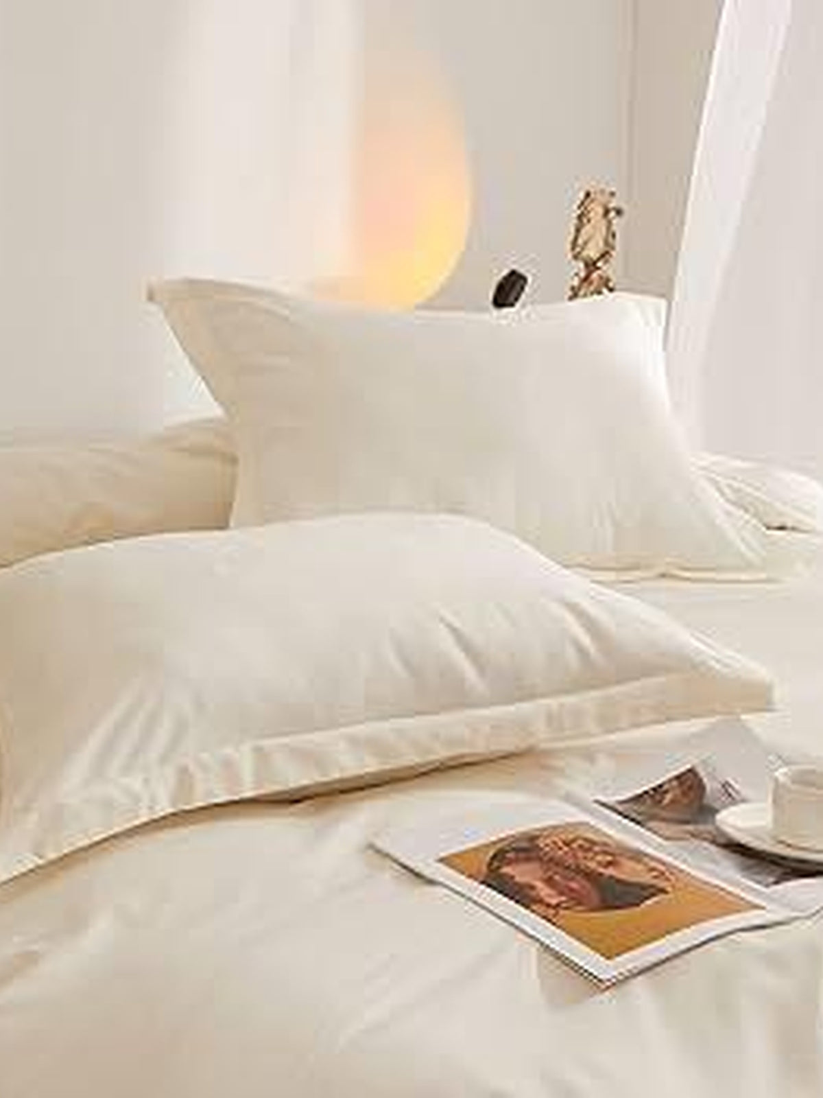 Oats beige cream sateen bedding and pillows on a made bed
