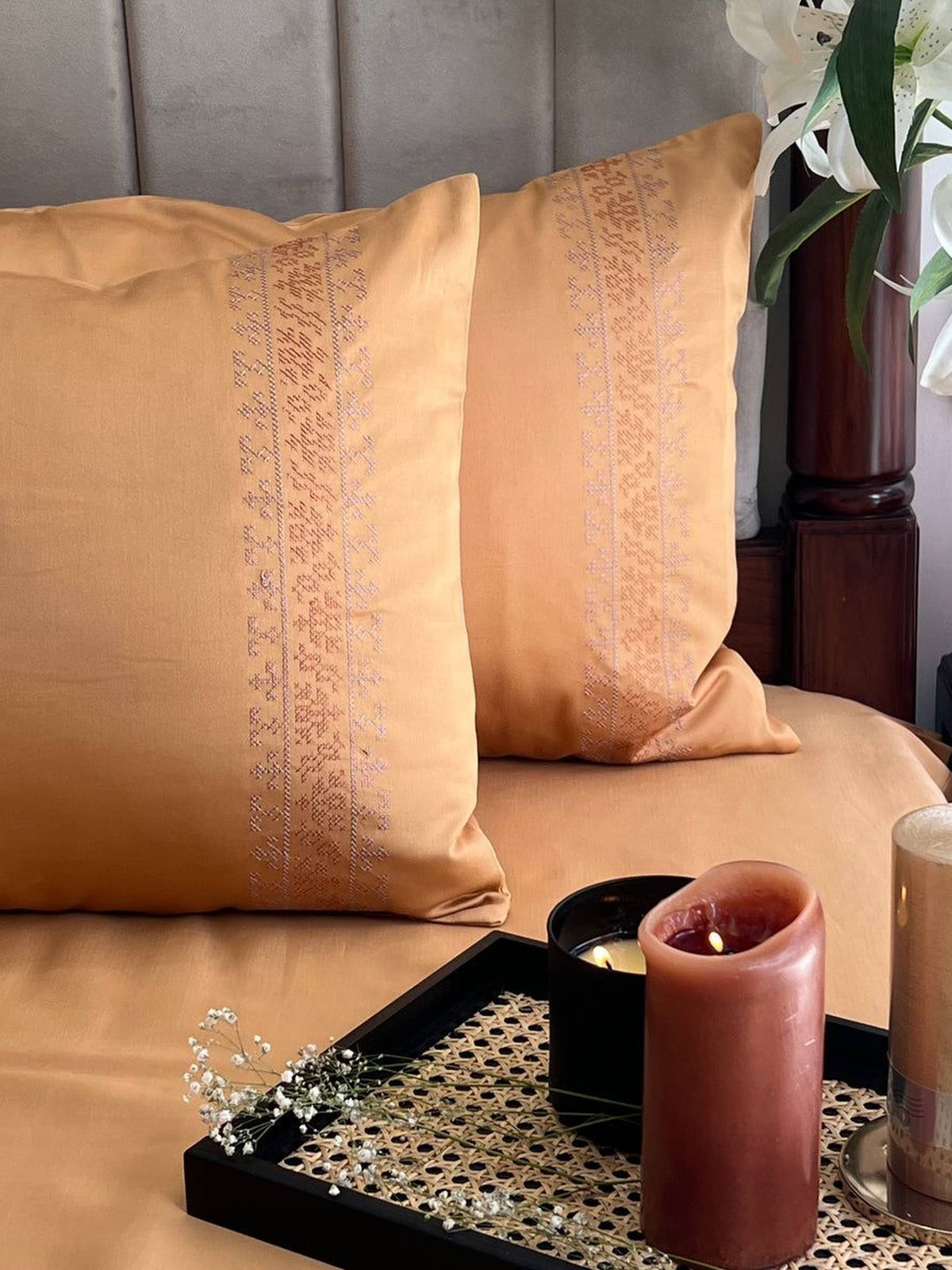Honey apricot bedding with a self-tone embroidered pillow band