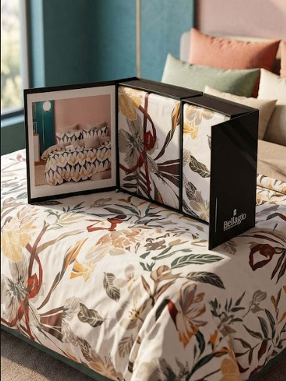 Bed dressed in a cream botanical print bedsheet with the open Voyage gift box