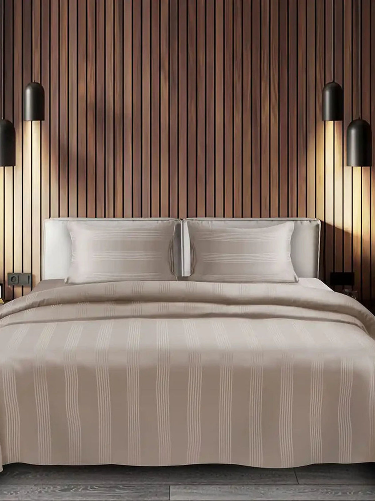 Taupe satin stripe cotton bedsheet on a made bed in a wood panelled bedroom