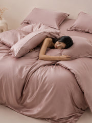 Dusty rose Tencel bedding set with duvet cover, made up on a bed
