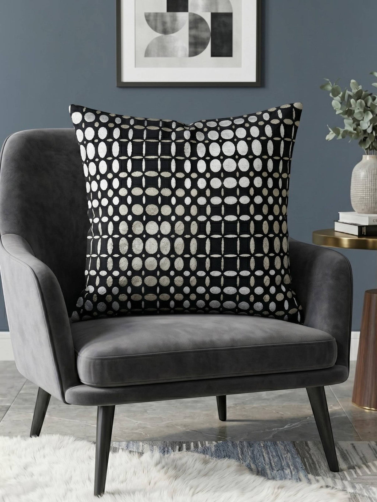 Black velvet cushion cover with geometric woven circular pattern in contrasting ivory tones