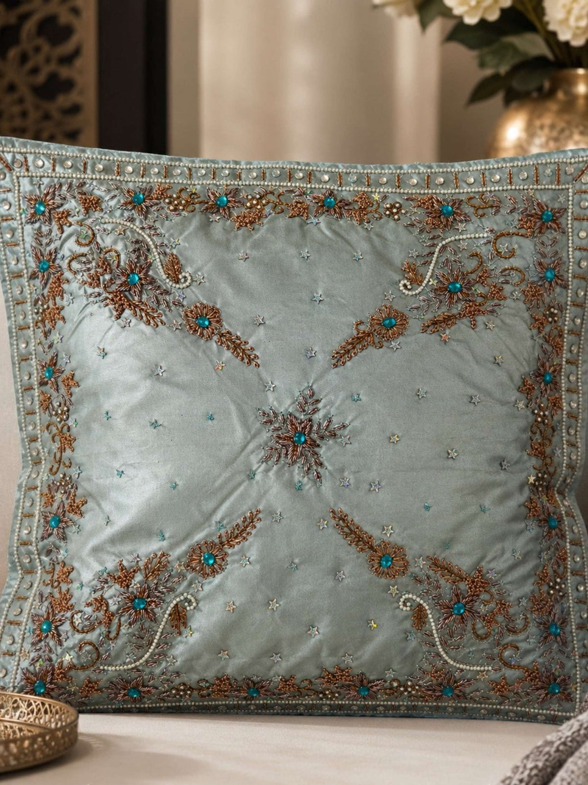 Jagdish Store light blue satin throw pillow cover with copper embroidery, sequins, and turquoise faux gemstones.