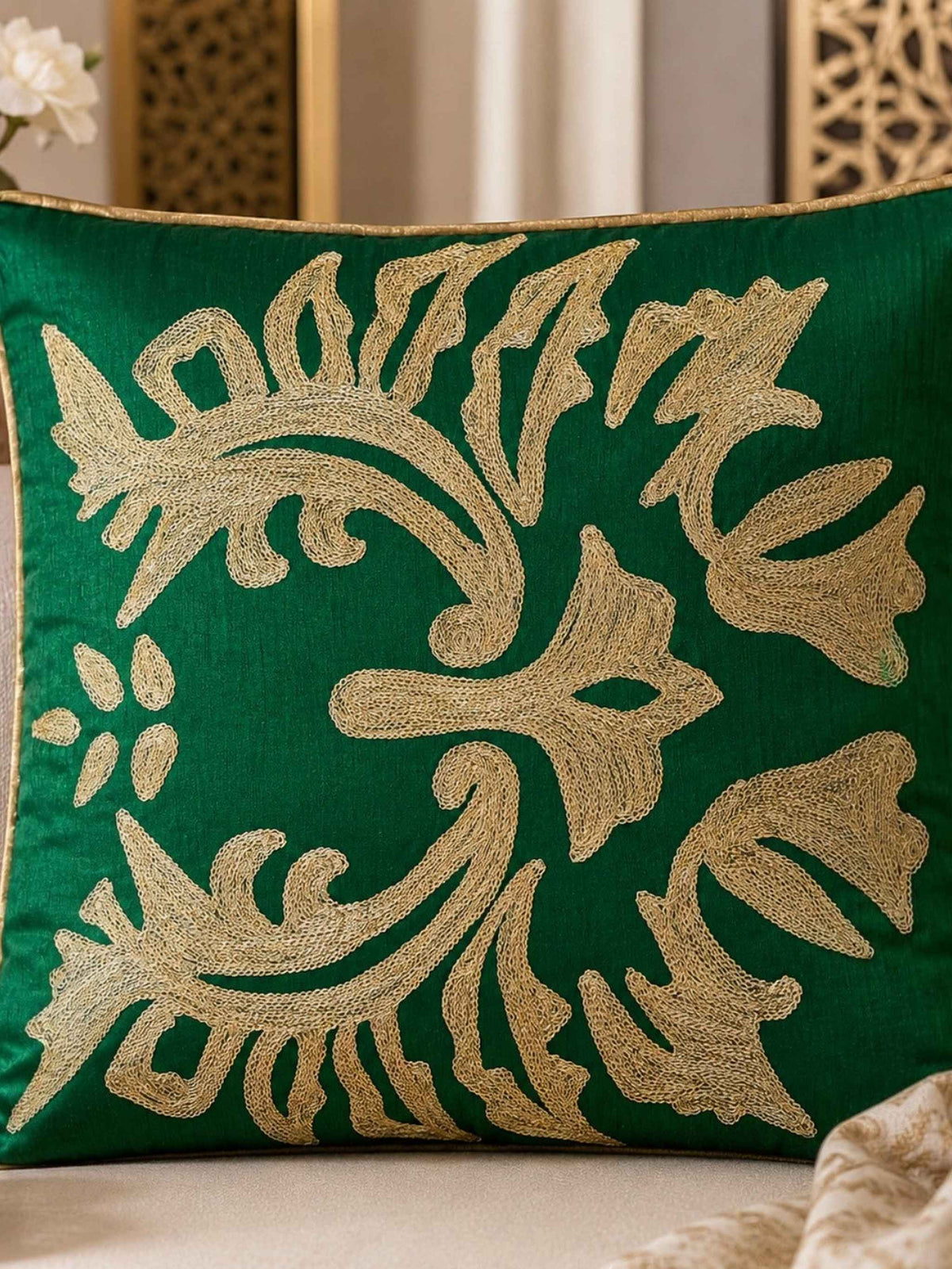 Jagdish Store emerald green throw Cushion cover with intricate shimmering gold floral embroidery and gold piping.