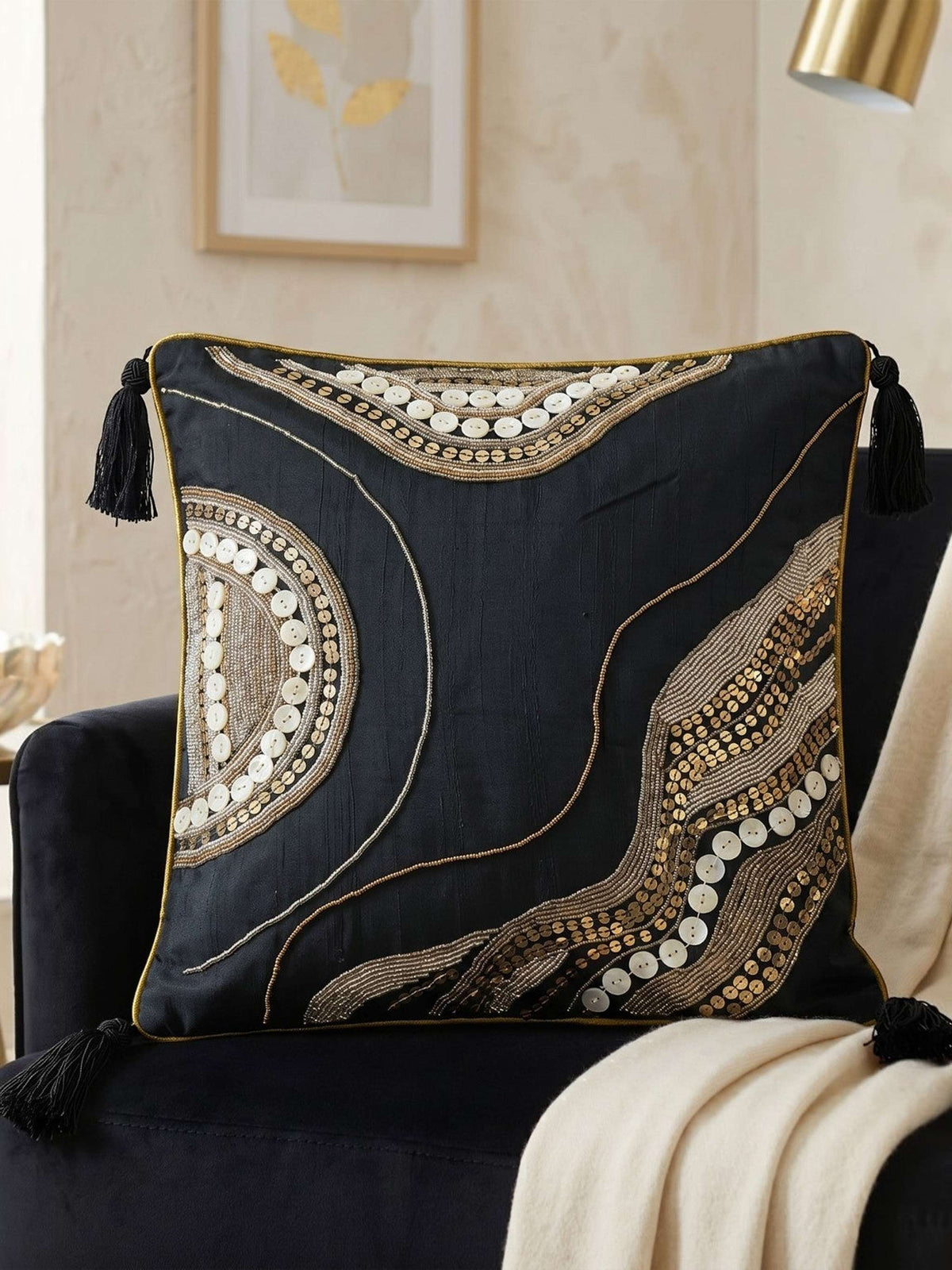 Jagdish Store midnight blue cushion cover with gold sequins, glass beads, white buttons, and black corner tassels.