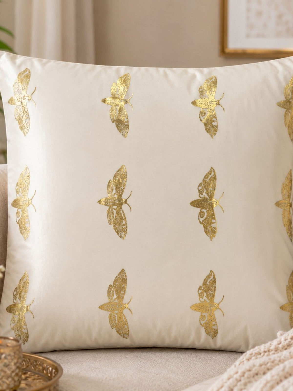 Jagdish Store off-white cushion cover with metallic gold Butterflies print and delicate embellishments.