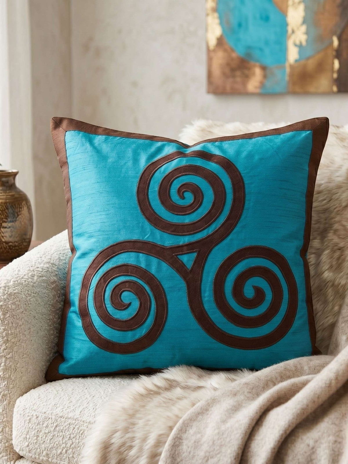 Jagdish Store turquoise cushion cover with a brown triskele spiral pattern and matching border.