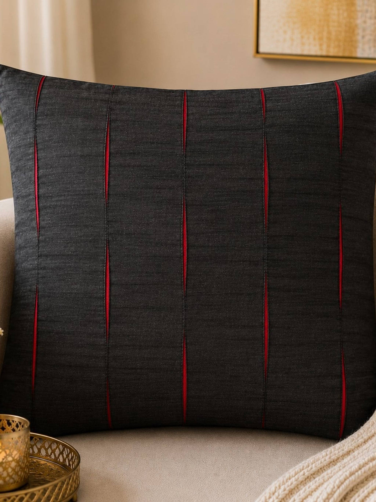 Jagdish Store black decorative throw cushion cover with pleated vertical channels revealing vibrant red accents.