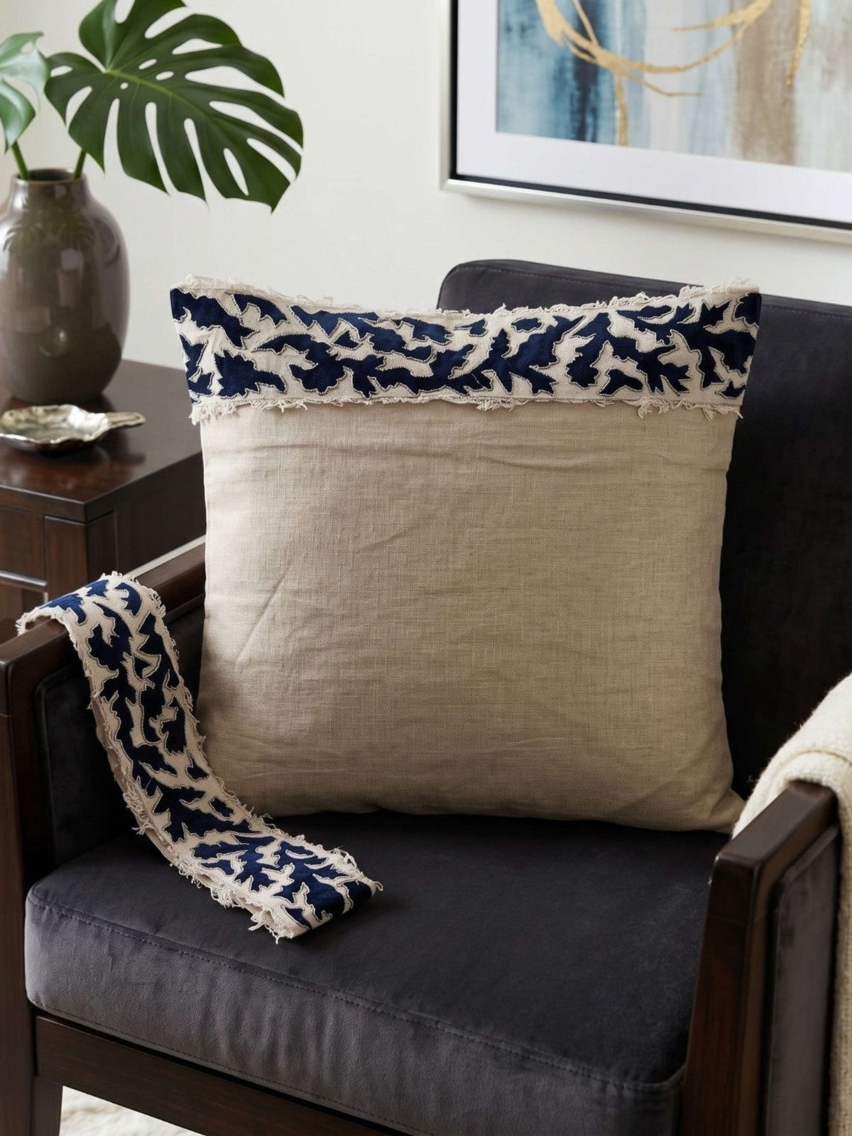 Beige cushion cover with detachable black patterned accent strip