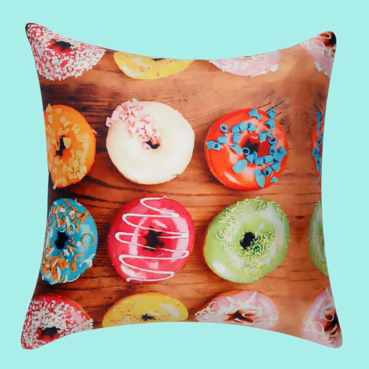 Cushion cover printed with iced doughnuts in bright colours on a wooden background