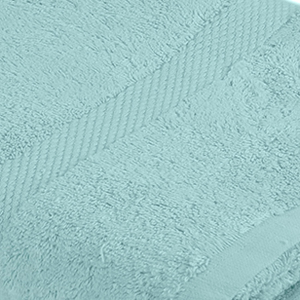 Pale sky-blue cotton bath towel folded flat with a herringbone woven border, close angle