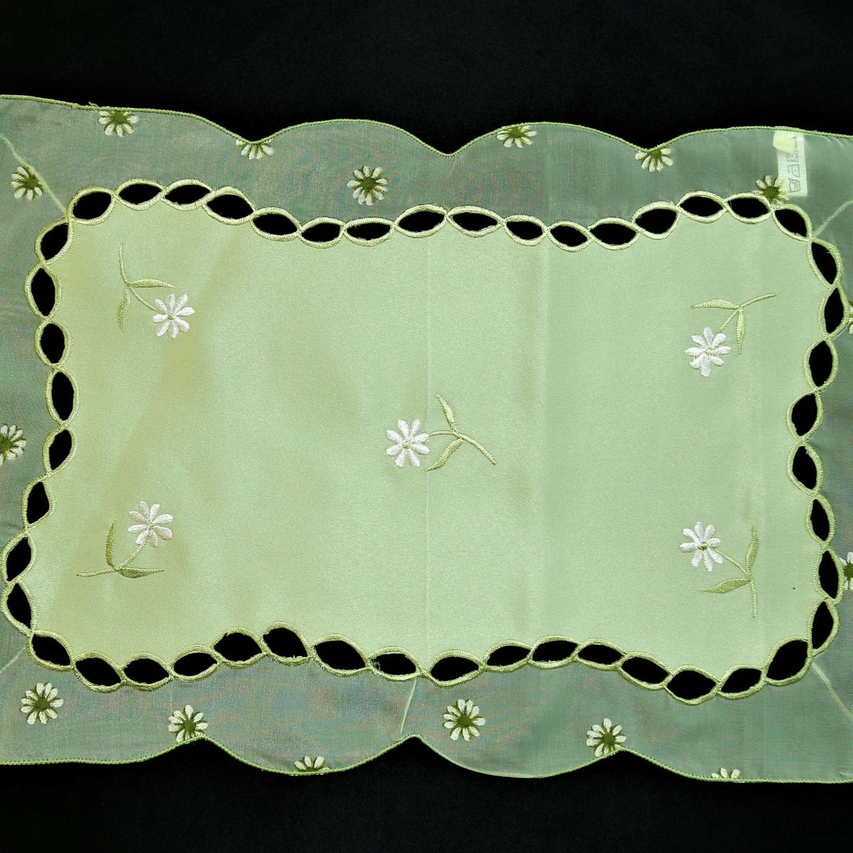 Green embroidered table mat close-up embroidery stitch detail