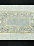 Cream tissue table mat embroidery stitch detail close-up