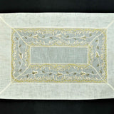 Cream tissue table mat embroidery stitch detail close-up