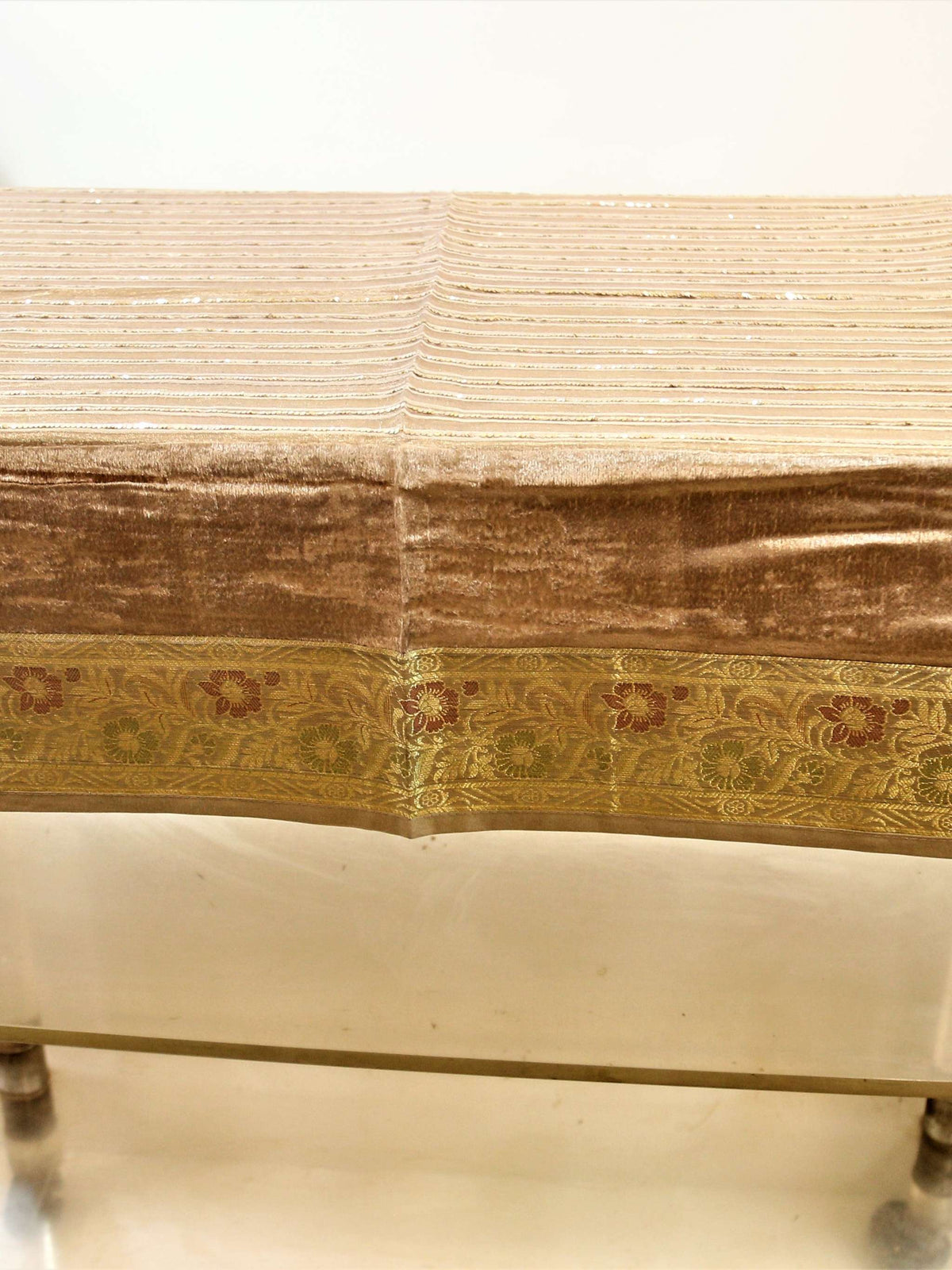 Champagne-beige velvet table cover with a sequinned stripe pattern and a gold brocade floral border