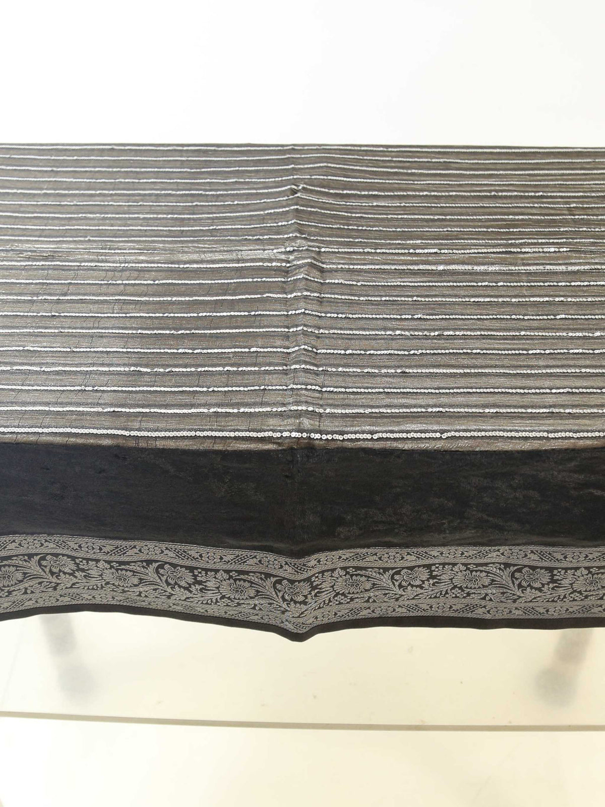 Black velvet table cover with a silver sequinned stripe pattern and a grey-gold floral brocade border