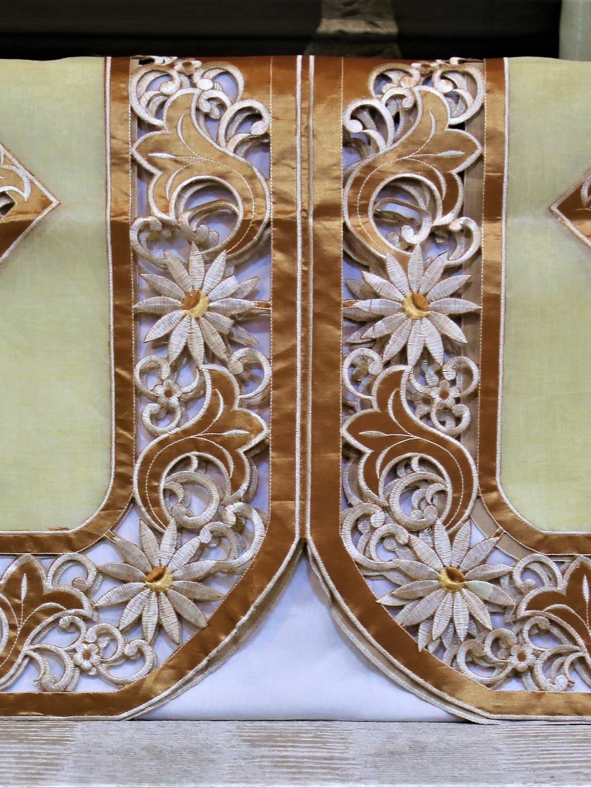 Pair of cream sofa back covers with copper cutwork embroidery, shown on a sofa, 23x25 inch