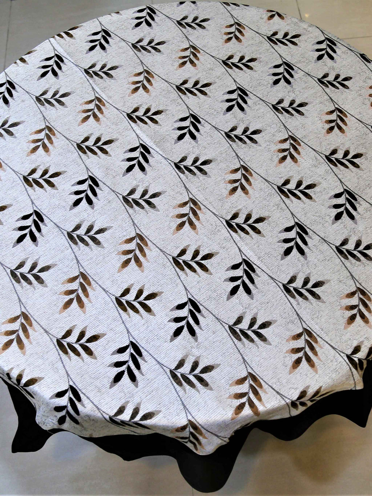 Round white table cover with a beige-brown leaf-vine print and a solid dark brown underskirt