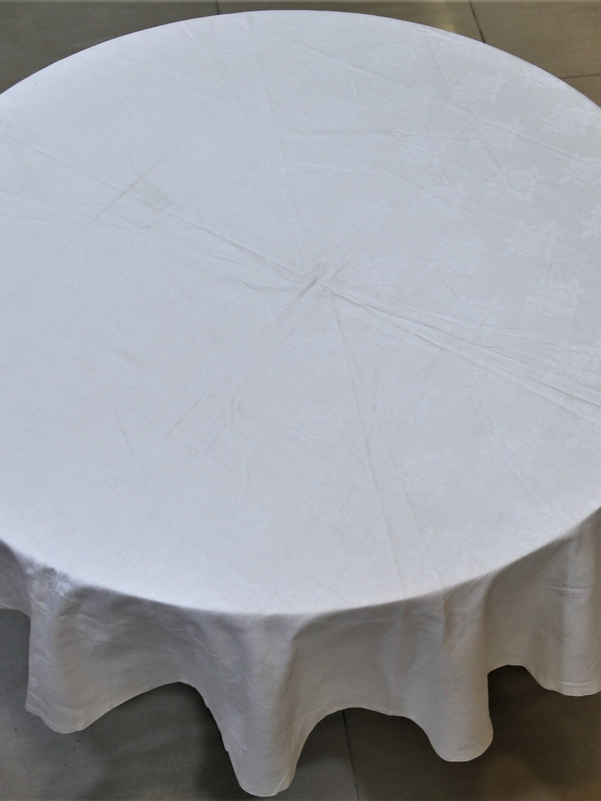 Round solid ivory cotton table cover with a self-jacquard texture