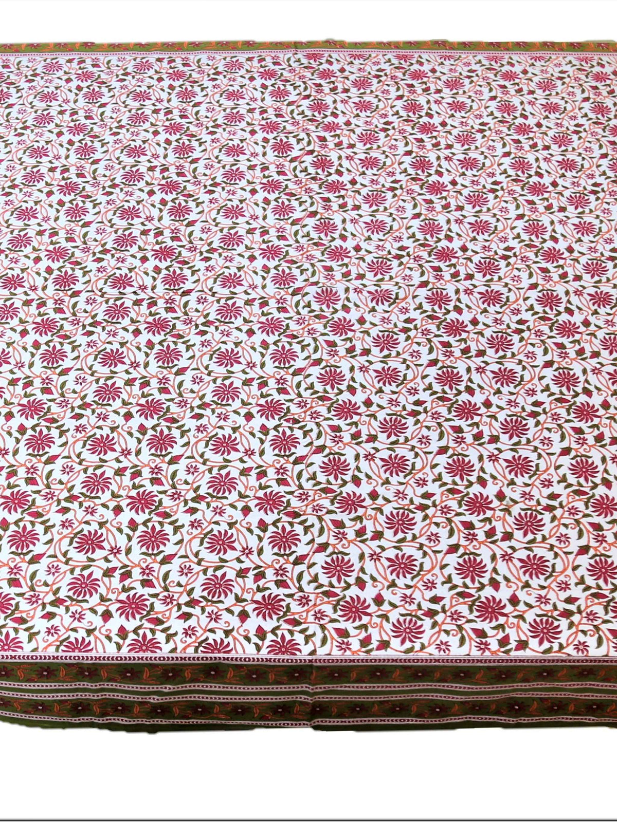 White table cover with a pink block-printed floral vine pattern and an olive-green border with a pink and maroon embroidered floral strip