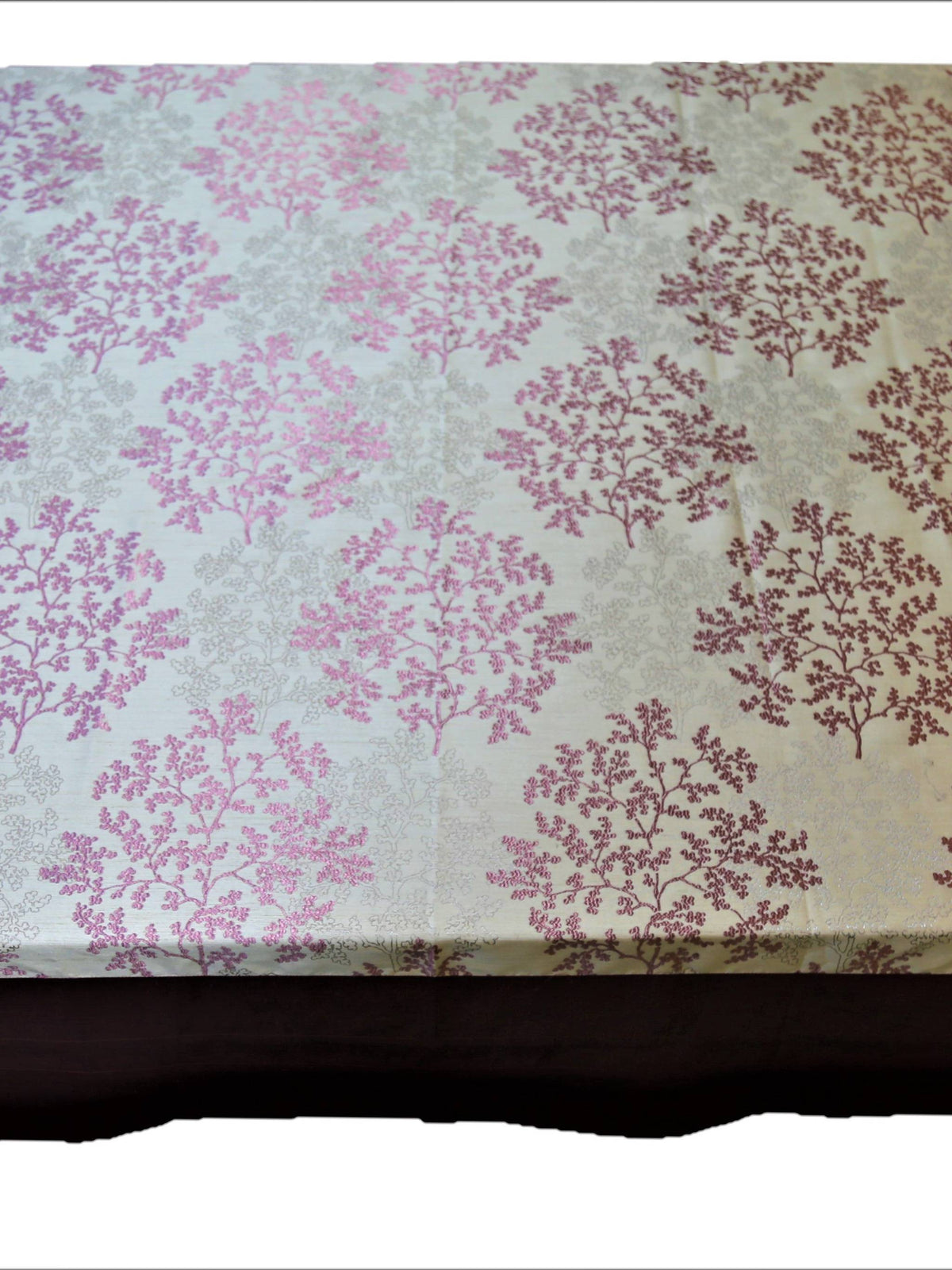 White table cover with a printed magenta tree-branch floral pattern and a solid maroon underskirt