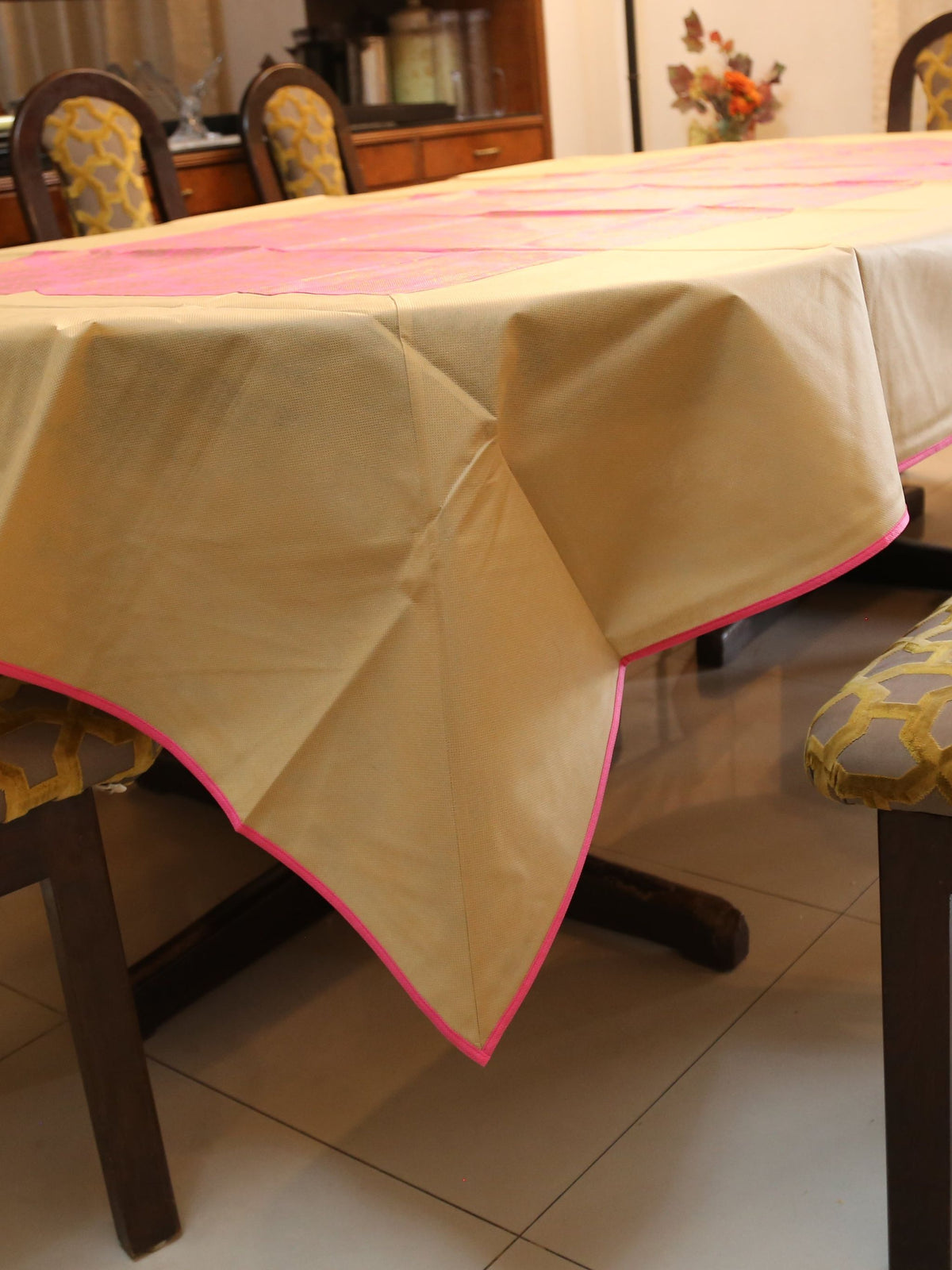 Gold-beige table cover with a contrasting pink brocade panel woven down the centre
