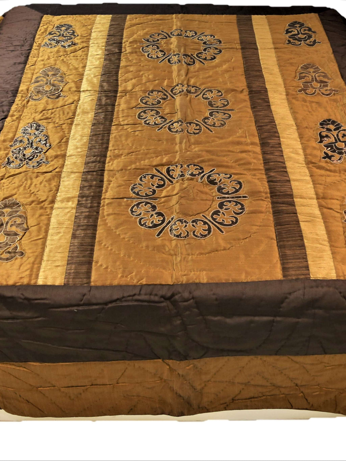 Brown and gold polycotton double bed quilt with striped patchwork panels and scroll embroidery