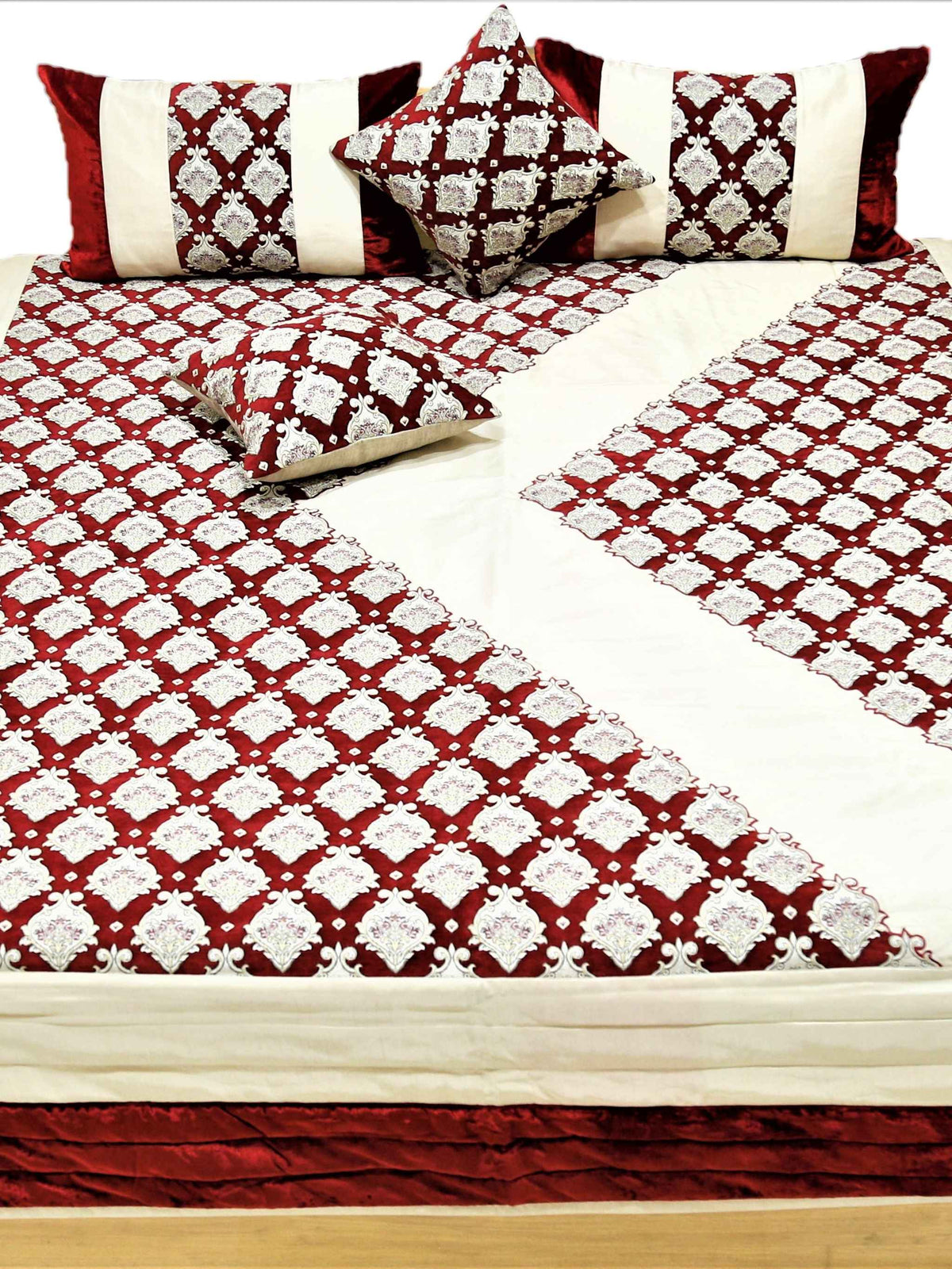 Maroon and cream quilted bedcover set with the corner turned back over the bed