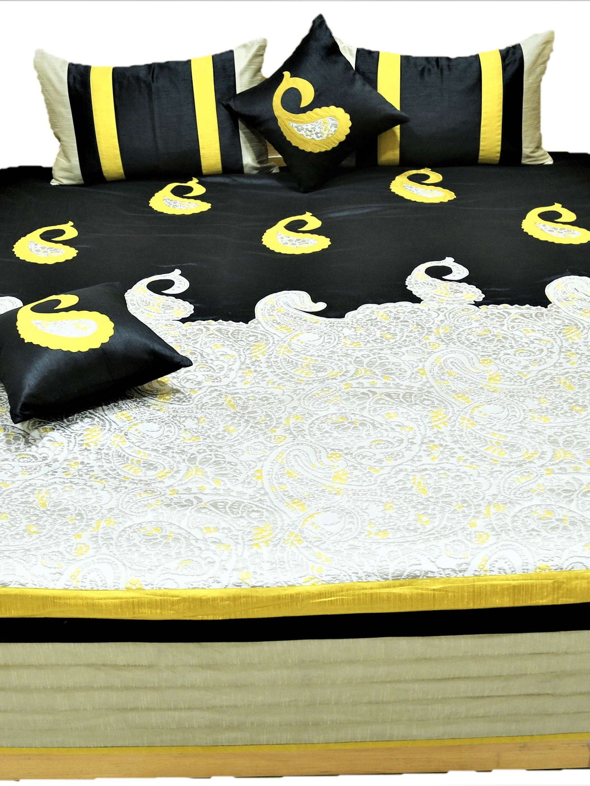 Black and ivory paisley bedcover flat view with striped bolster and cushion covers