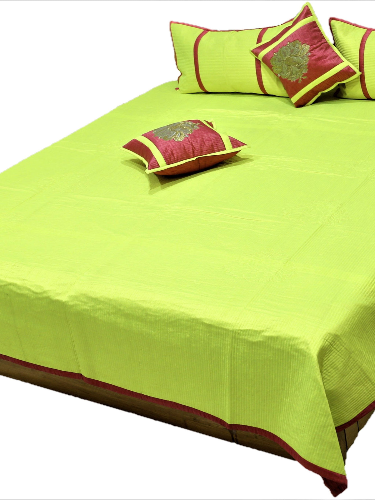 Lime green reverse side of the bedcover with maroon and gold zari cushion covers