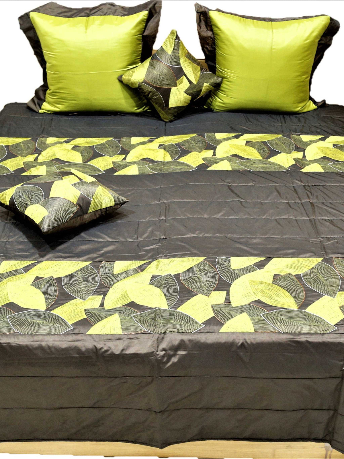 Front view of the brown and lime leaf quilted bedcover set on a double bed