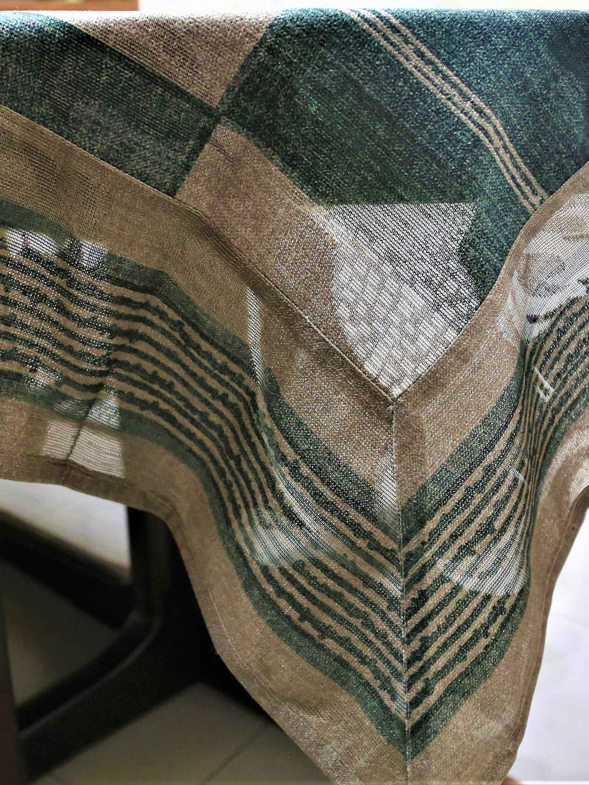 Green and cream checkered table cover with a self-tone floral jacquard pattern and a sheer green underskirt