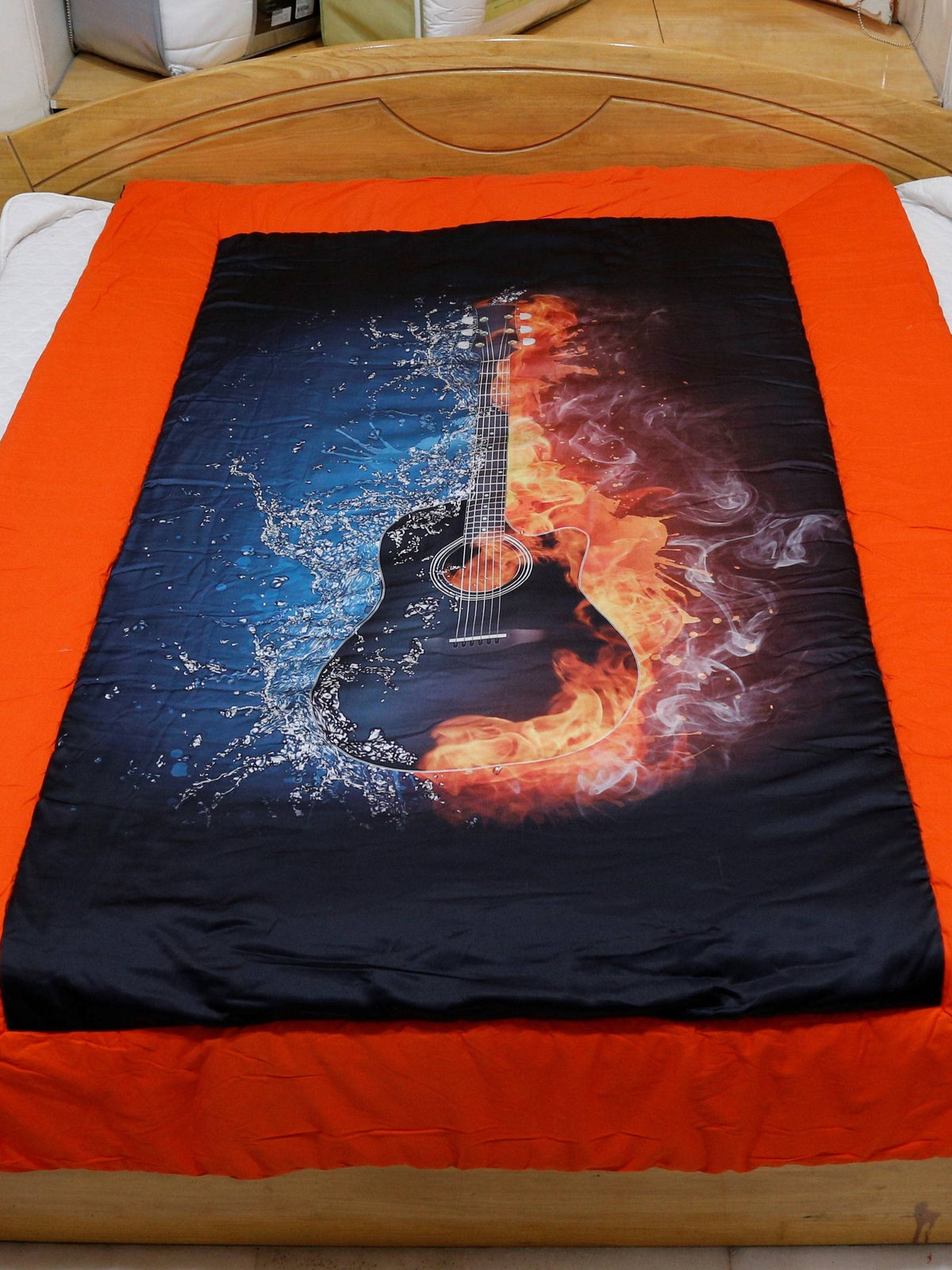 Orange-bordered polyester single bed quilt with flaming guitar graphic print