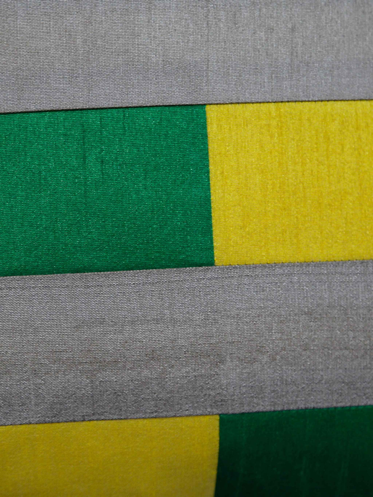 Close up of the grey, green and yellow pieced colour blocks and their seams